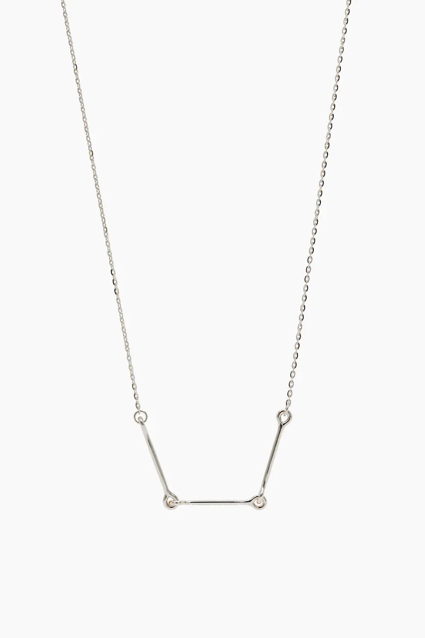 Front-facing product image of the Iris Necklace in 14k white gold, featuring three polished bars connected with rounded loops.