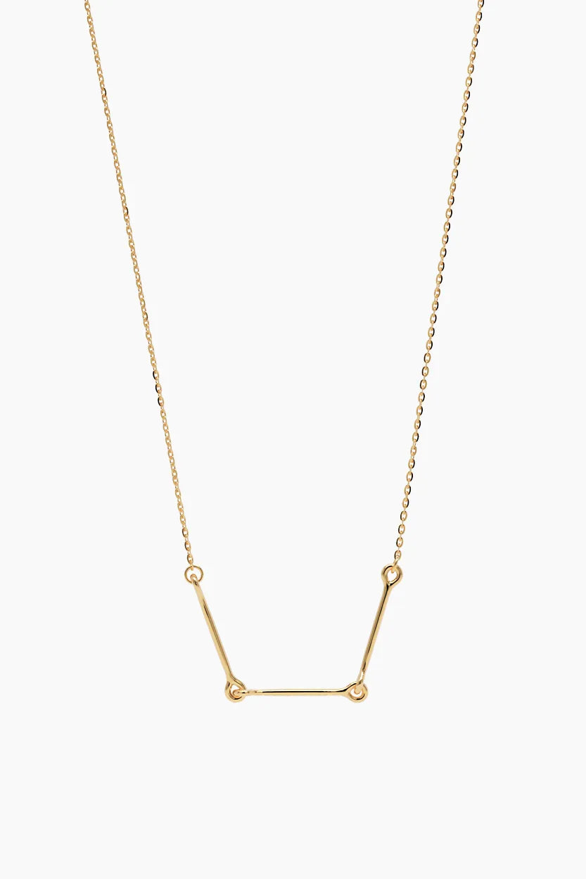Front-facing product image of the Iris Necklace in 14k yellow gold, featuring three polished bars connected with rounded loops.