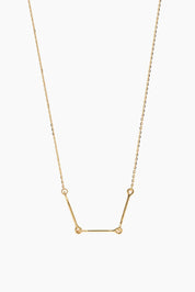 Front-facing product image of the Iris Necklace in 14k yellow gold, featuring three polished bars connected with rounded loops.
