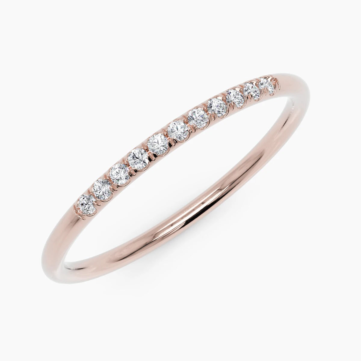 14k rose gold thin pave diamond band ring, close up angled view showing row of set diamonds on white background