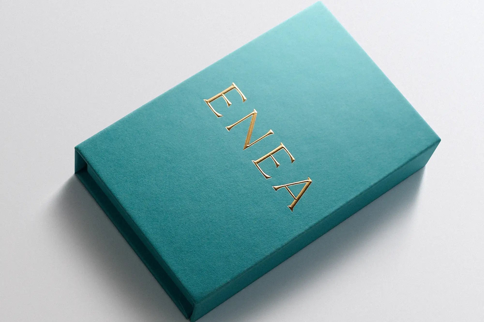 teal jewelry gift box with gold ENEA lettering for fine jewelry packaging