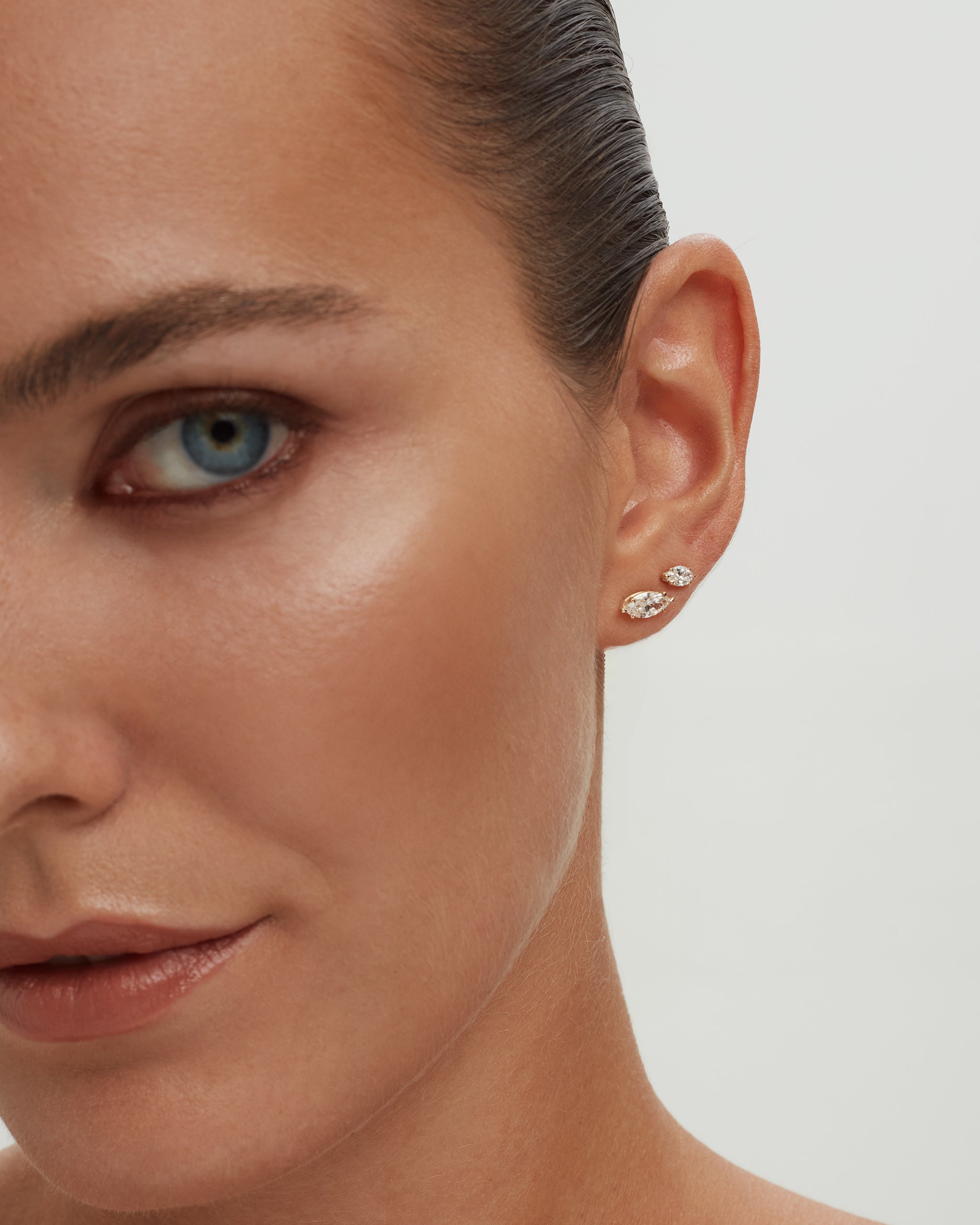 Model wearing marquise diamond studs in 14k yellow gold, ENEA Studio