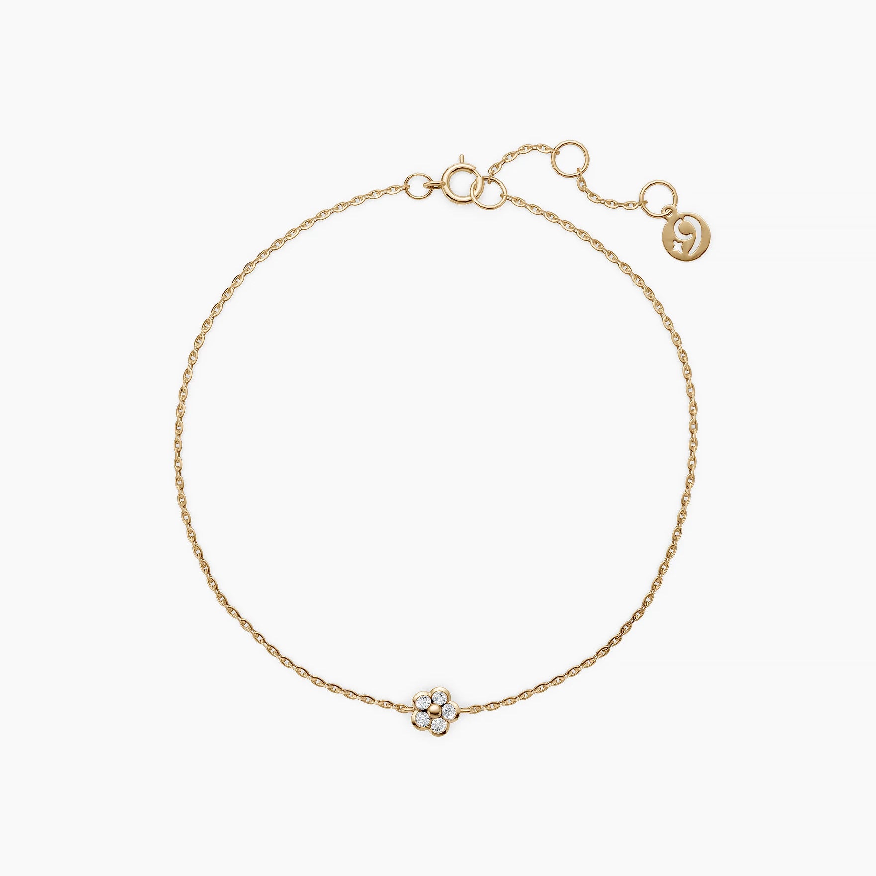Solid gold petite petal diamond bracelet top down view on white background showing flower shaped diamond charm on a delicate chain