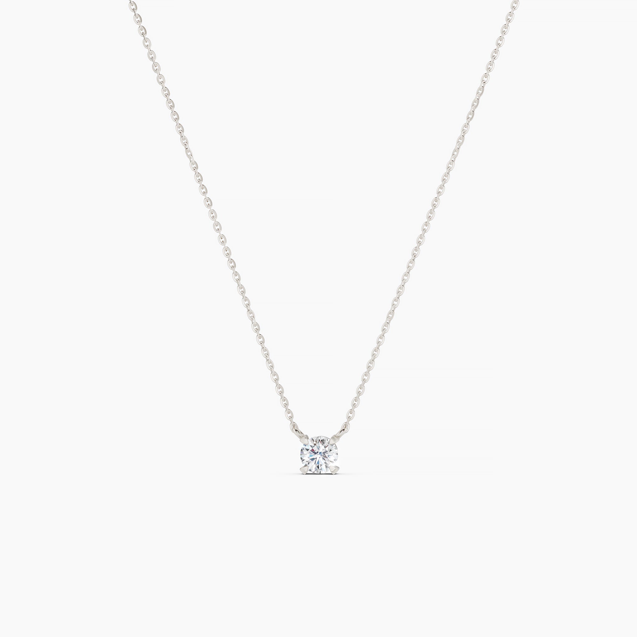 White gold necklace with a small diamond pendant on a grey background