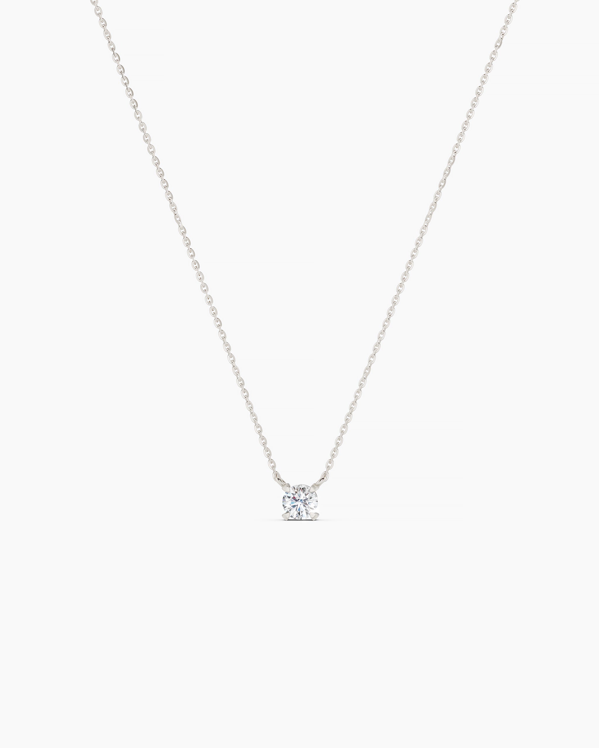 White gold necklace with a small diamond pendant on a grey background