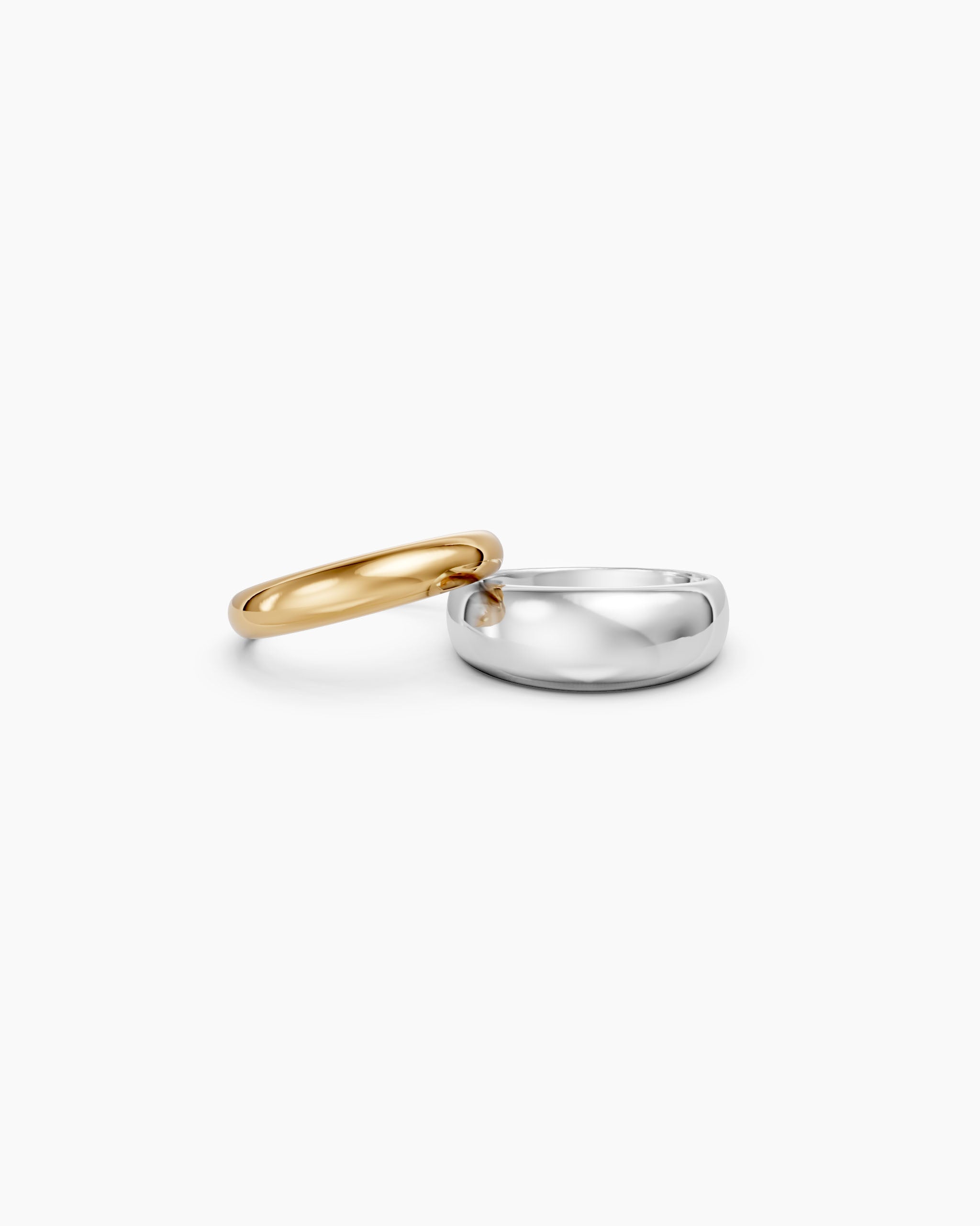 DYO Dome Stacking Ring set, gold and silver bands separated, three-quarter view.