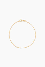 Close-up of 14k solid gold bracelet with polished bead details, laid flat with clasp visible


