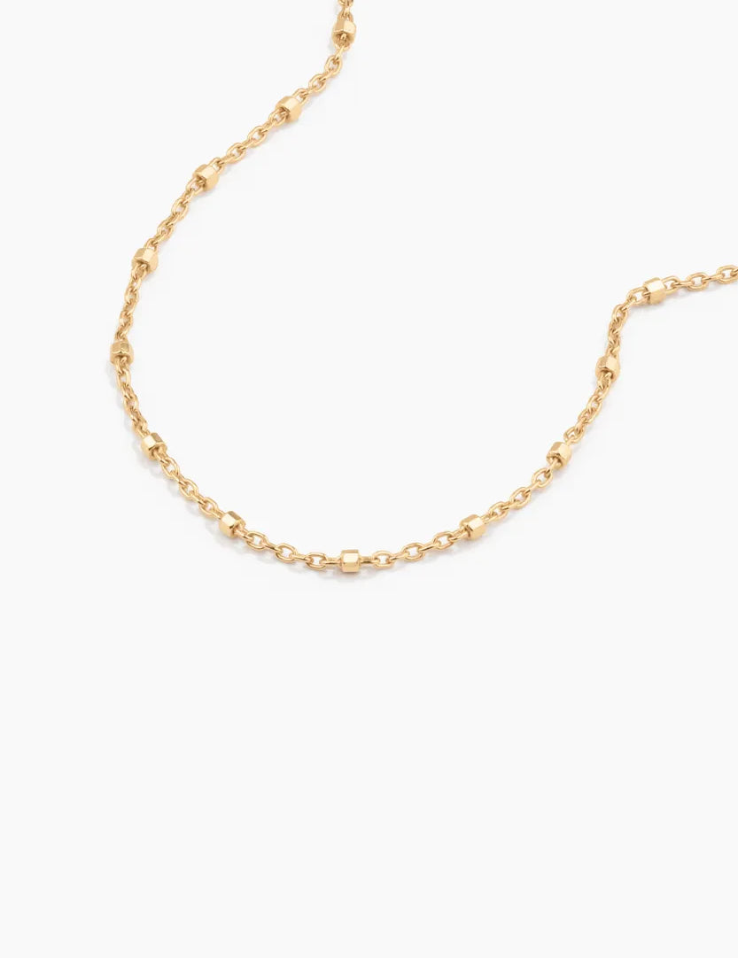 Macro detail of fine gold chain with soft hex beads, 14k solid gold bracelet by ENEA

