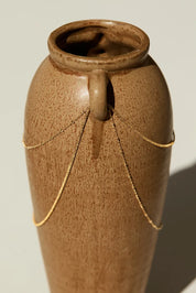 14k gold bracelet draped over ceramic vase, showing chain length and bead spacing, photographed in natural light

