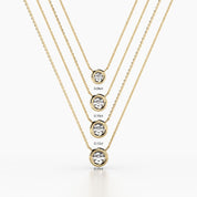 Five gold bezel-set diamond necklaces shown in a vertical arrangement, labeled by size from top to bottom: 0.06ct, 0.10ct, 0.12ct, and 0.15ct.
