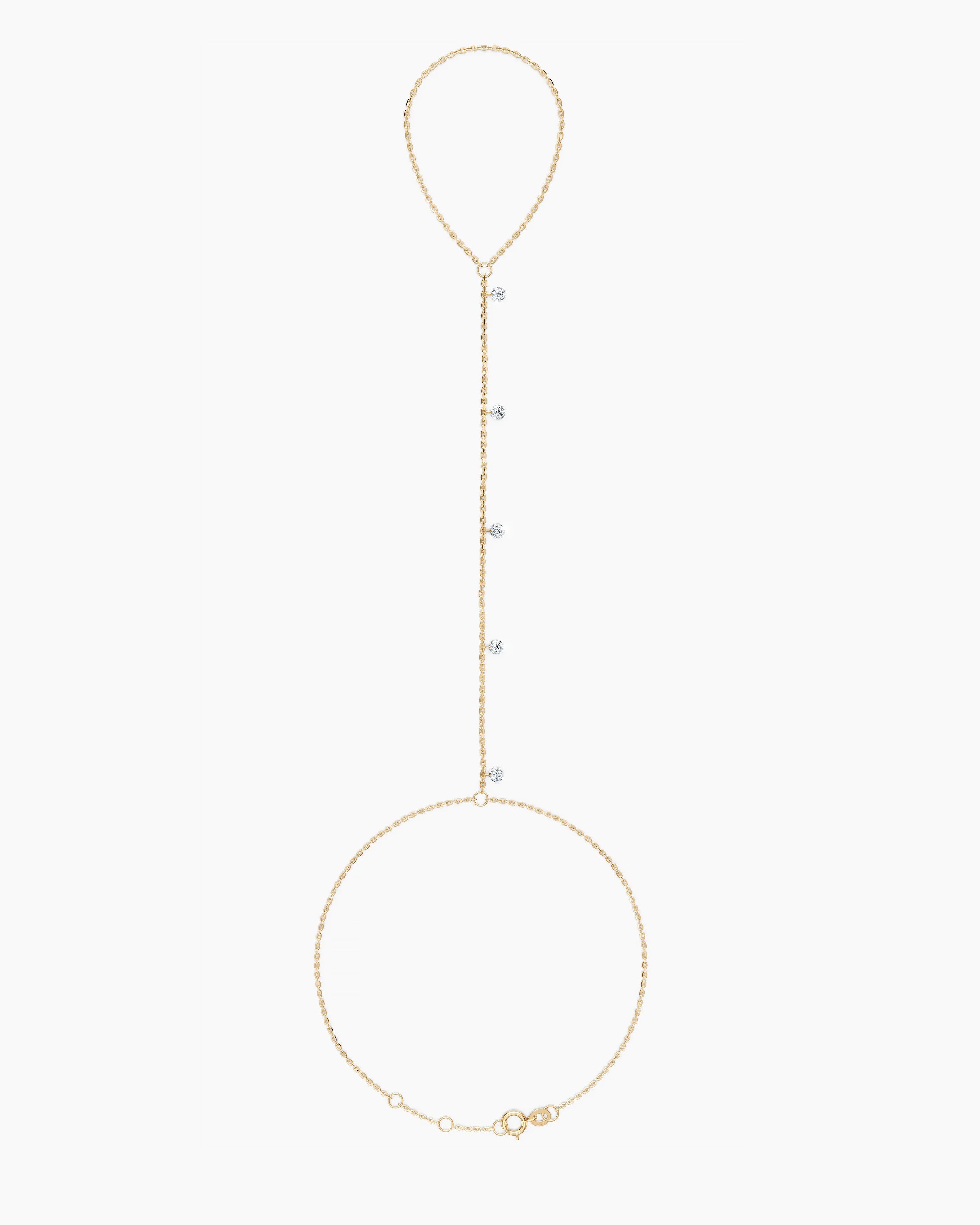 Gold  hand chain bracelet with small rounddiamonds on a white background