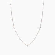 Rose gold necklace featuring five delicate white diamonds spaced evenly along a fine chain, displayed on a white background.
