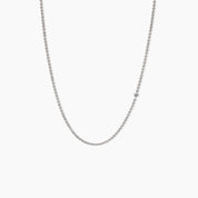 Minimalist white gold necklace featuring a single small diamond set along a fine chain, displayed against a clean white background.
