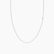 white gold chain diamond necklace on a light gray background