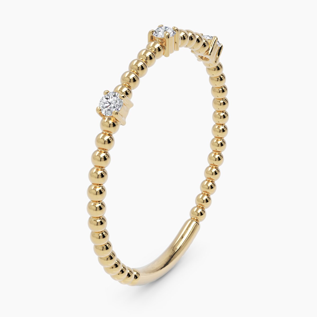 4k yellow gold diamond beaded ring displayed in a vertical position at an angle, showcasing its delicate gold bead details and three prong-set round diamonds. A refined stacking ring with a unique perspective.