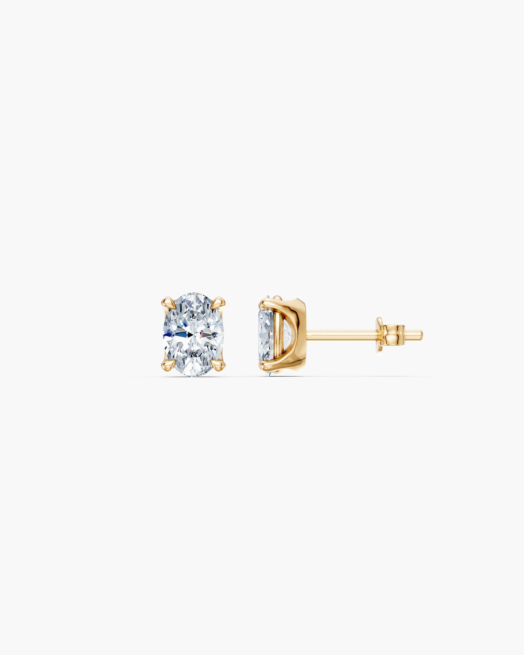 Oval lab diamond stud in 14k yellow gold, front and side view showing the four prong basket and push back, ENEA Studio