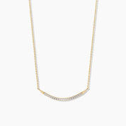 14k yellow gold curved bar necklace with pavé diamonds, shown on a white background to highlight the delicate arc and sparkle.
