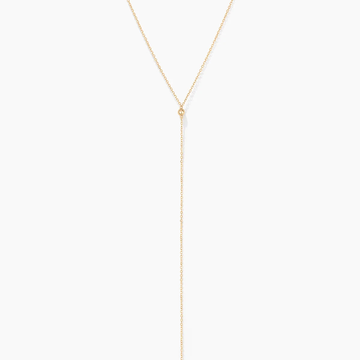 solid gold beaded lariat necklace with gold beads on delicate cable chain on white background