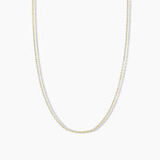 Minimalist yellow gold necklace with evenly spaced round diamonds set along a delicate cable chain, displayed on a white background.
