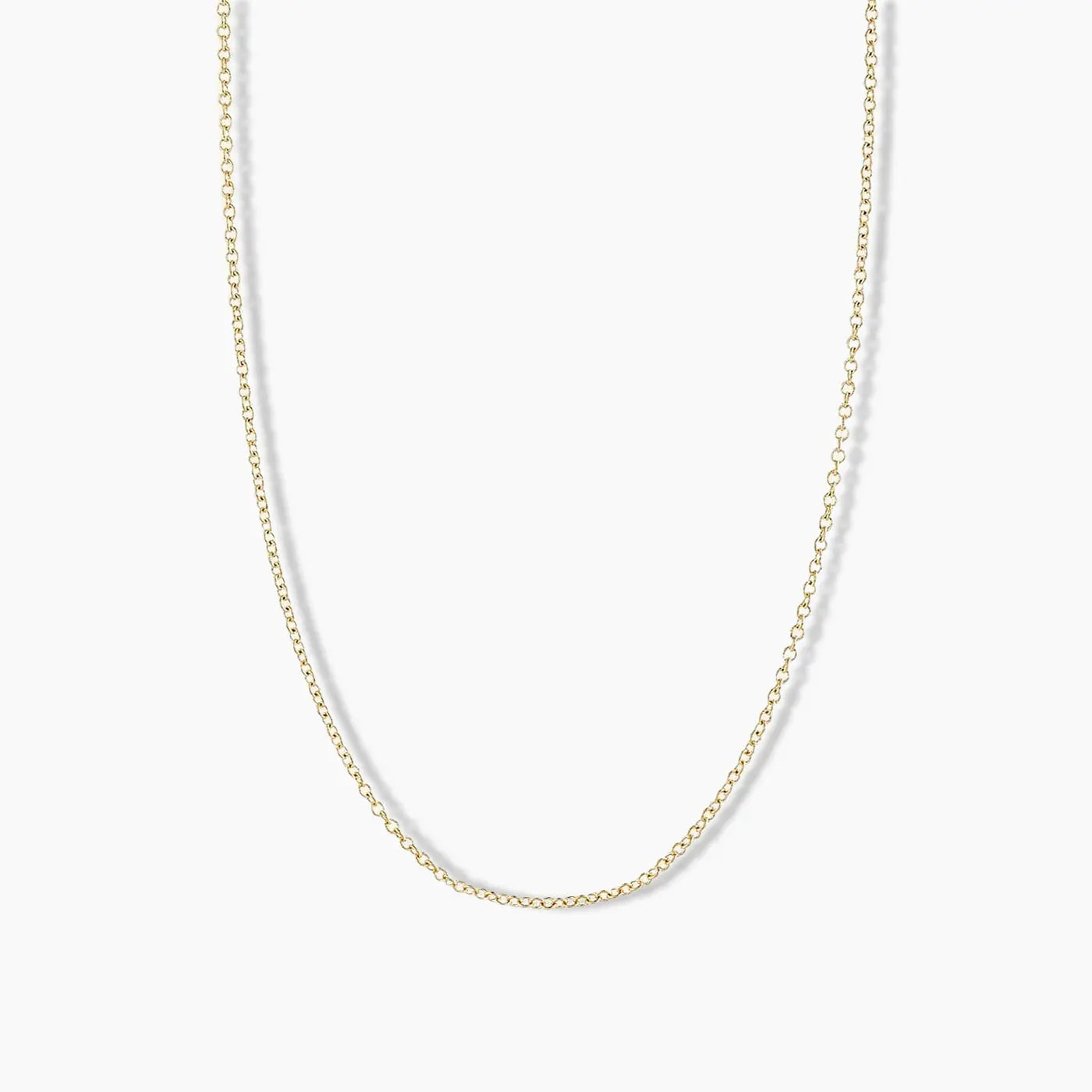 Minimalist yellow gold necklace with evenly spaced round diamonds set along a delicate cable chain, displayed on a white background.
