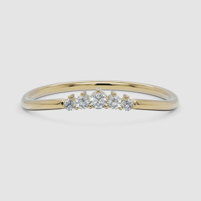 video showcasing the diamond arc ring in yellow gold, rotating to display its elegant curvature and sparkle from all angles
