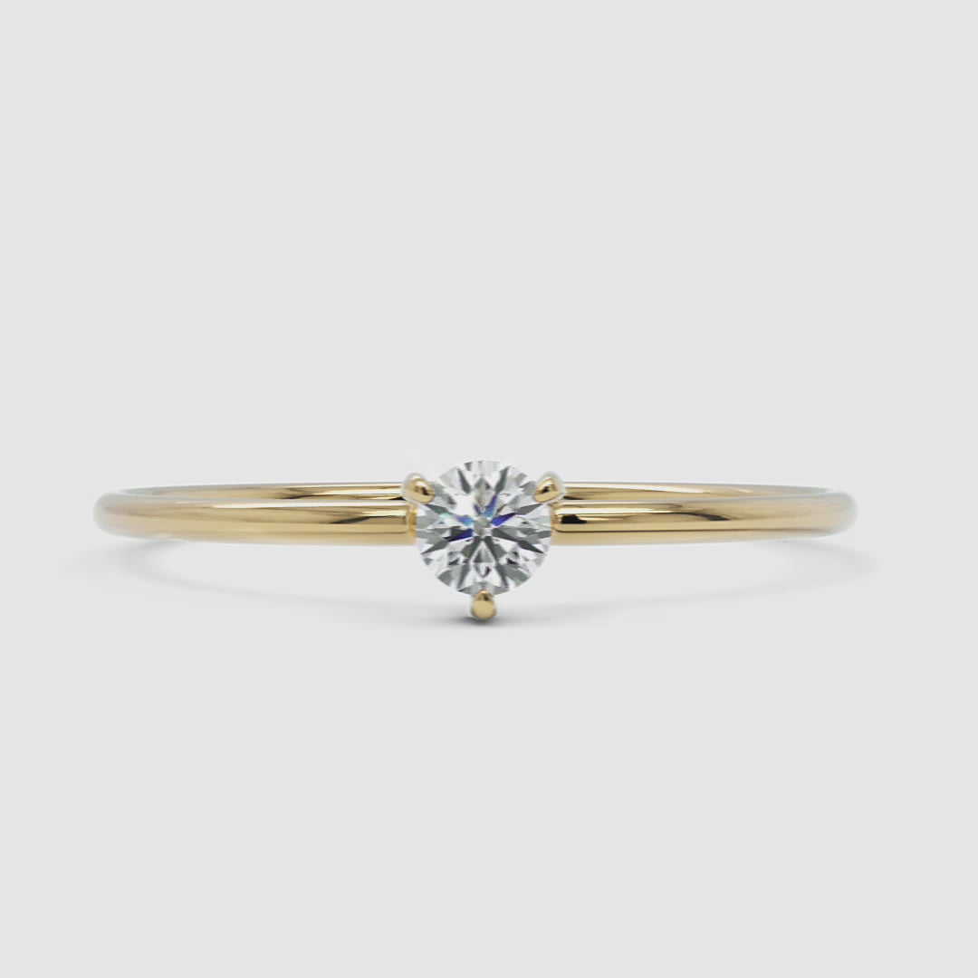 A 360-degree video of a 14k yellow gold solitaire diamond ring, rotating to display its delicate band and round brilliant-cut diamond in a classic four-prong setting. The video highlights the ring’s fine craftsmanship and elegant shine from every angle.