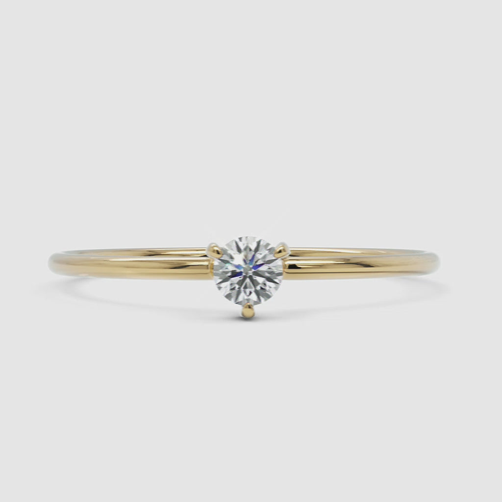 A 360-degree video of a 14k yellow gold solitaire diamond ring, rotating to display its delicate band and round brilliant-cut diamond in a classic four-prong setting. The video highlights the ring’s fine craftsmanship and elegant shine from every angle.