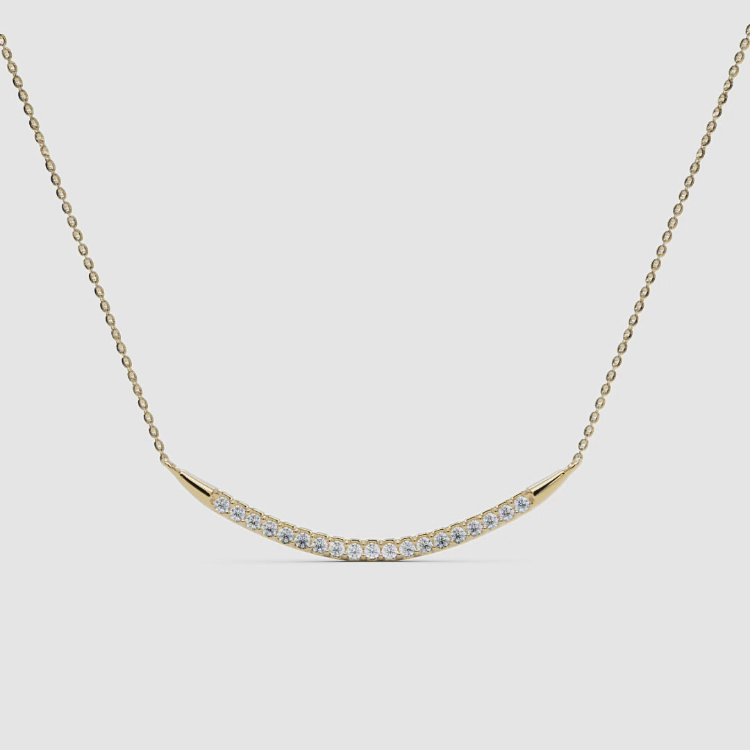 360 view of the yellow gold curved diamond bar pendant, showcasing the craftsmanship and setting.
