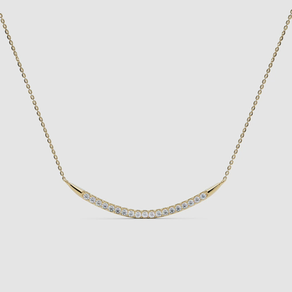 360 view of the yellow gold curved diamond bar pendant, showcasing the craftsmanship and setting.