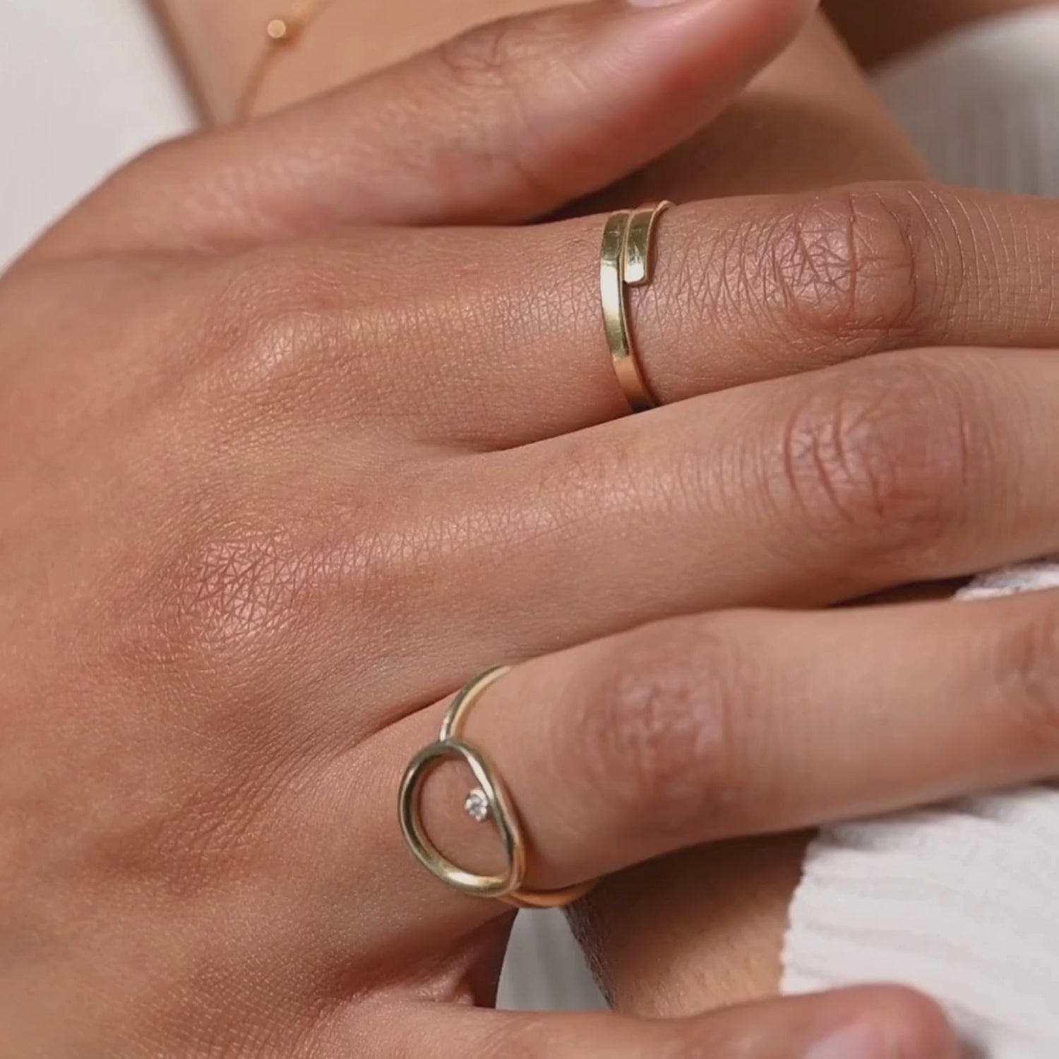 video of a model showcasing the dainty spiral ring in rose gold, with natural movements that emphasize the subtle sparkle and unique twisted design
