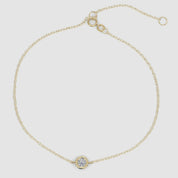 Adjustable bezel-set diamond bracelet in yellow gold displayed flat to show chain details and secure clasp mechanism.

