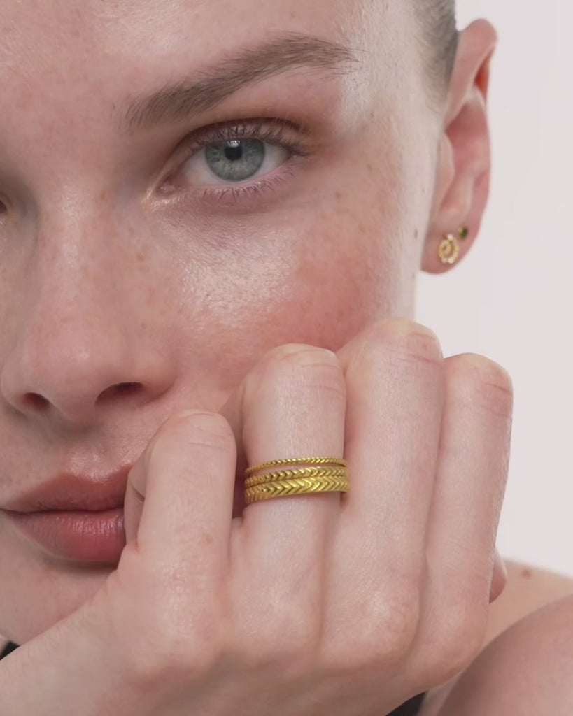 Video of the model wearing the Lefkandi Chevron Ring in 14k yellow gold, the chevrons catching light as her hand moves, ENEA Studio