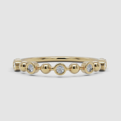 A 360-degree video of a 14k yellow gold beaded diamond ring, smoothly rotating to showcase its bezel-set diamonds and polished gold spheres from every angle.