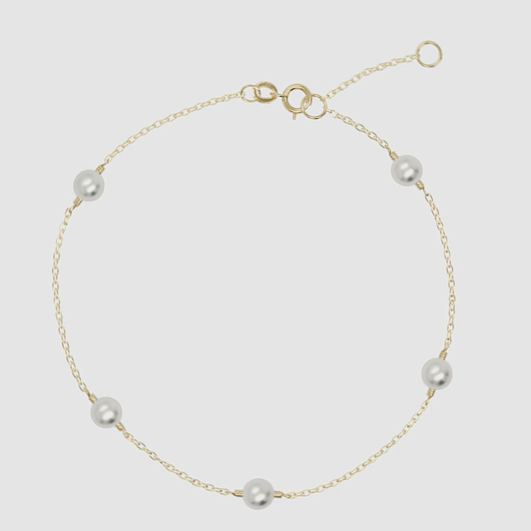 Multi pearl bracelet in 14k yellow gold with adjustable clasp and dainty freshwater pearls.