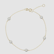 Multi pearl bracelet in 14k yellow gold with adjustable clasp and dainty freshwater pearls.