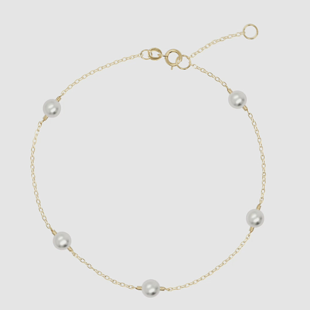 Multi pearl bracelet in 14k yellow gold with adjustable clasp and dainty freshwater pearls.