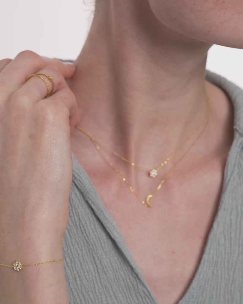 Video of a woman wearing the Selas Diamond Cluster Bracelet in 14k yellow gold, the seven diamond cluster catching light as her wrist moves. ENEA Studio