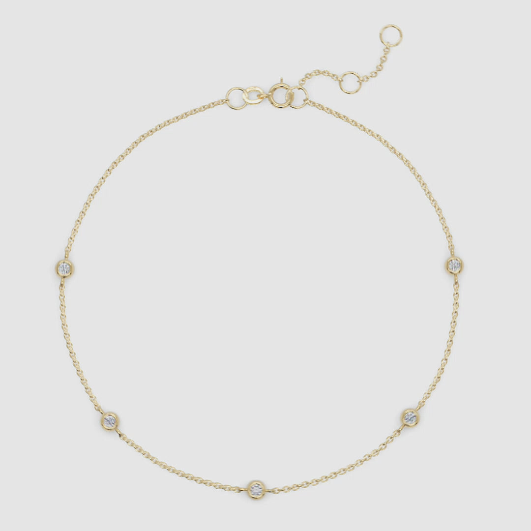 Full view of gold station bracelet with clearly visible spring clasp and adjustable extender for fit versatility.

