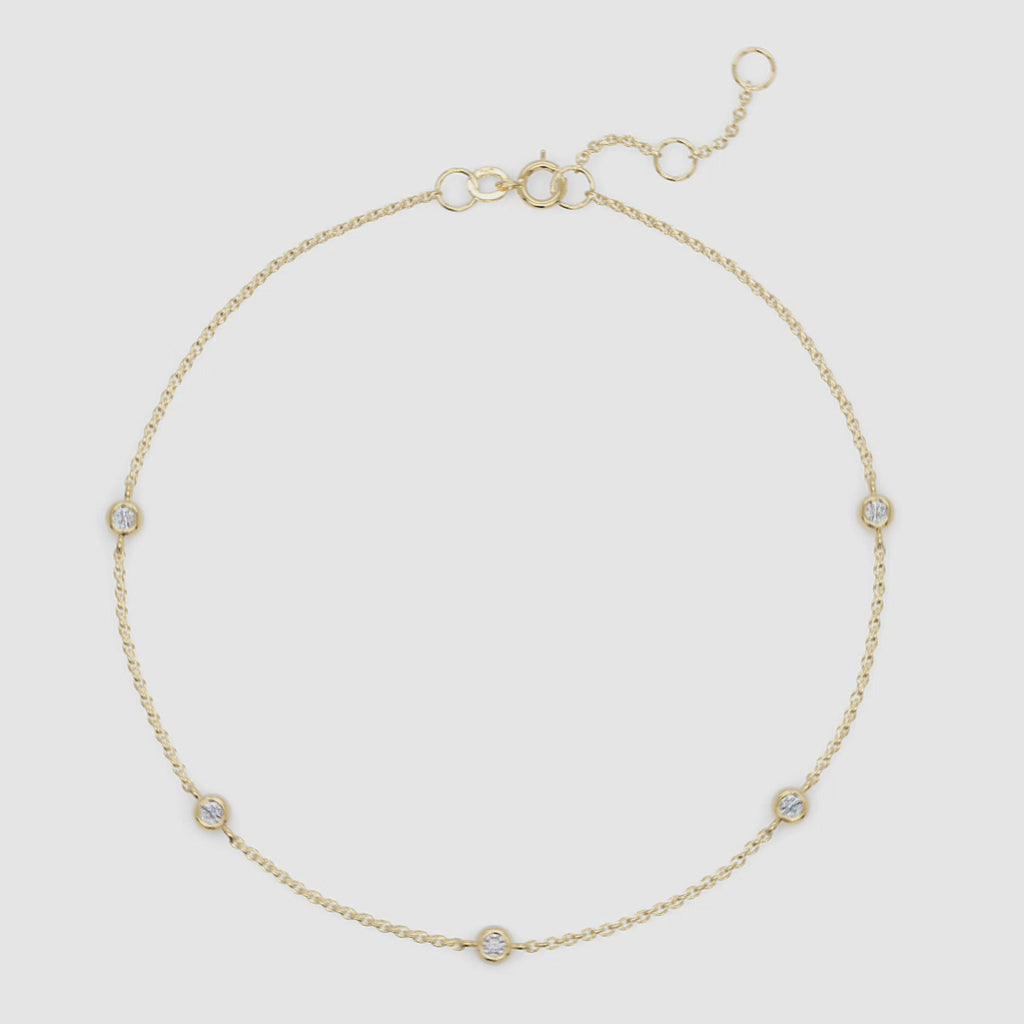 Full view of gold station bracelet with clearly visible spring clasp and adjustable extender for fit versatility.

