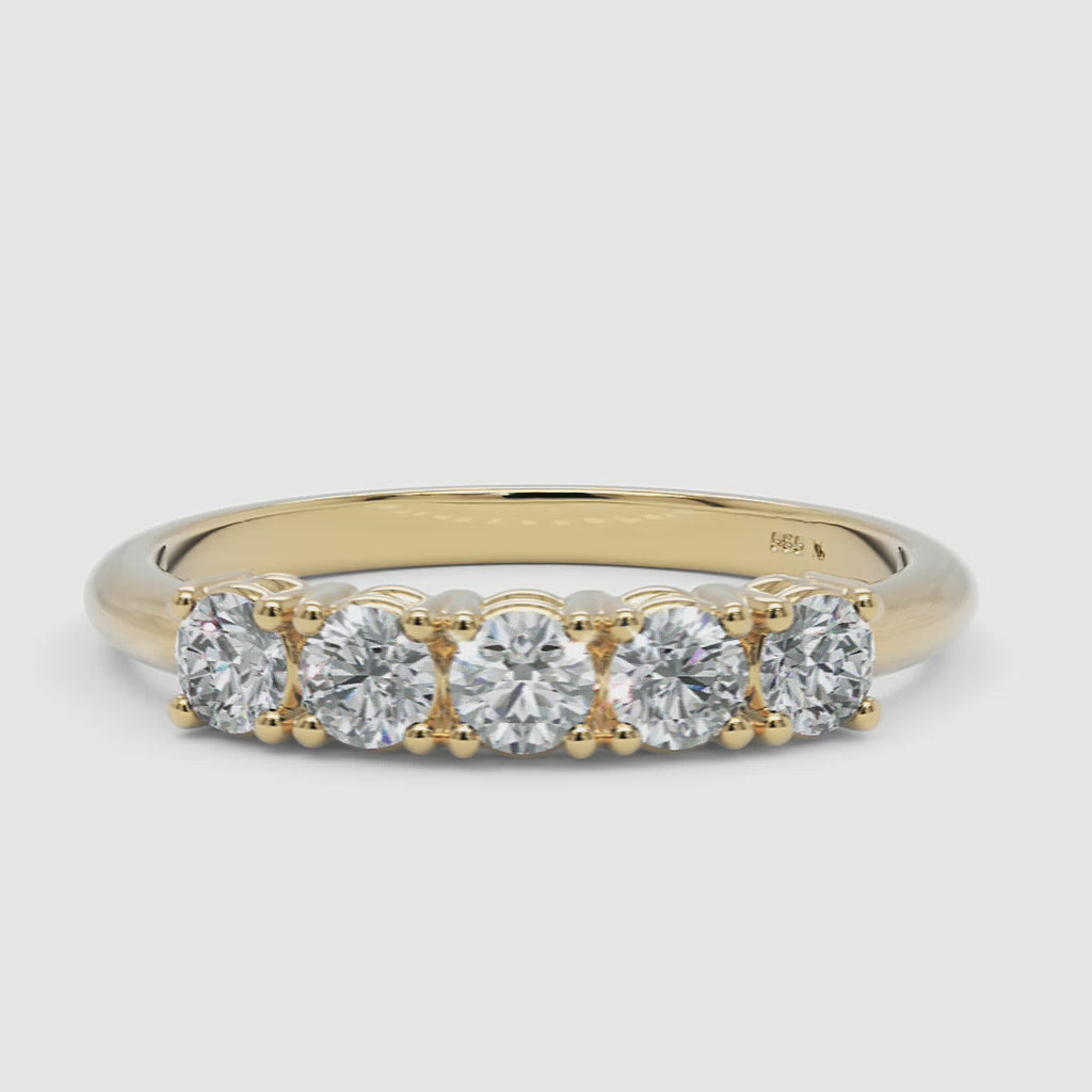 360-degree video of the yellow gold five-stone diamond ring, smoothly rotating to reveal the prong-set diamonds and polished gold band
