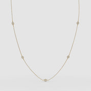 Product VIDEO of the diamond station necklace in yellow gold, displayed in a gentle arc to highlight each bezel-set stone.