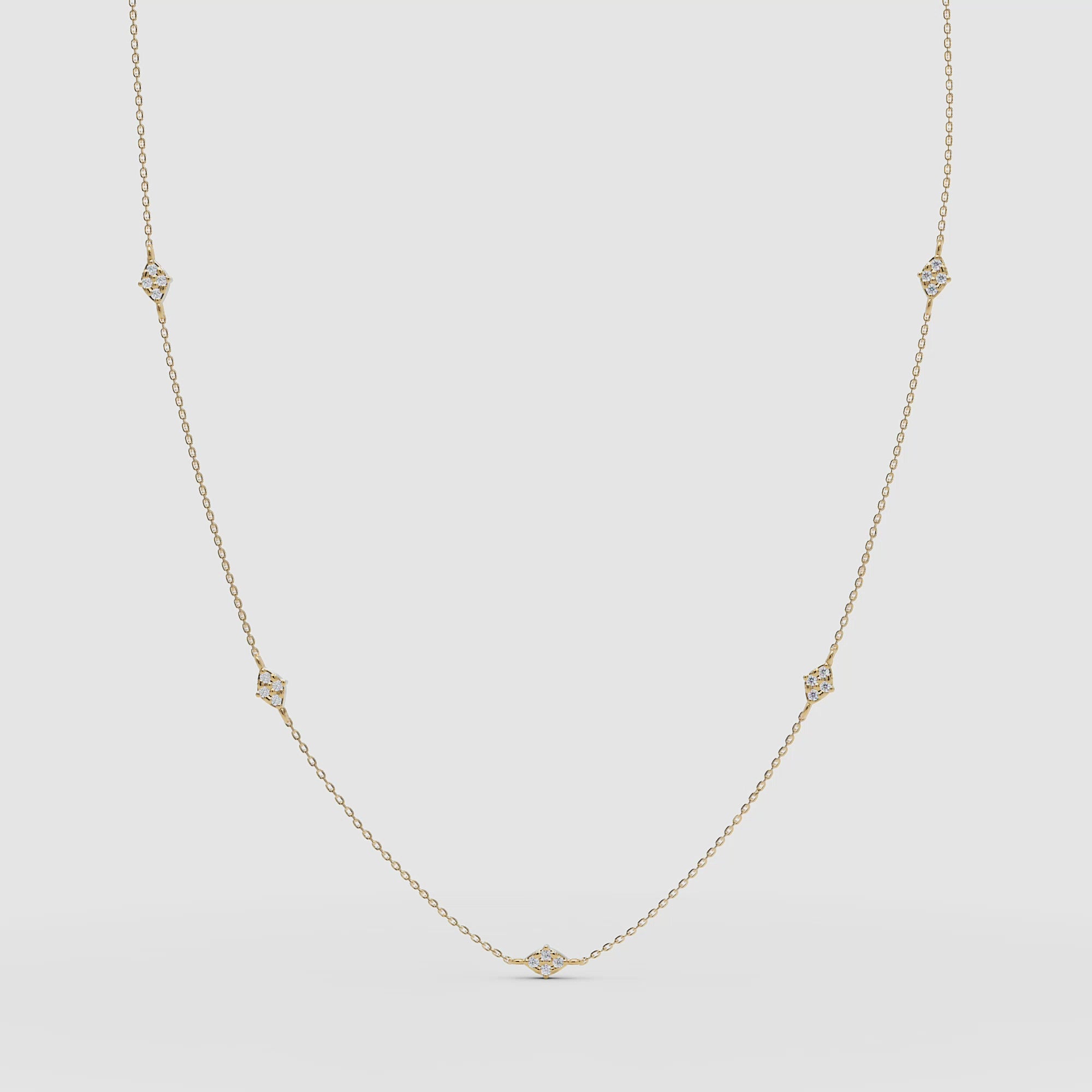 Product VIDEO of the diamond station necklace in yellow gold, displayed in a gentle arc to highlight each bezel-set stone.