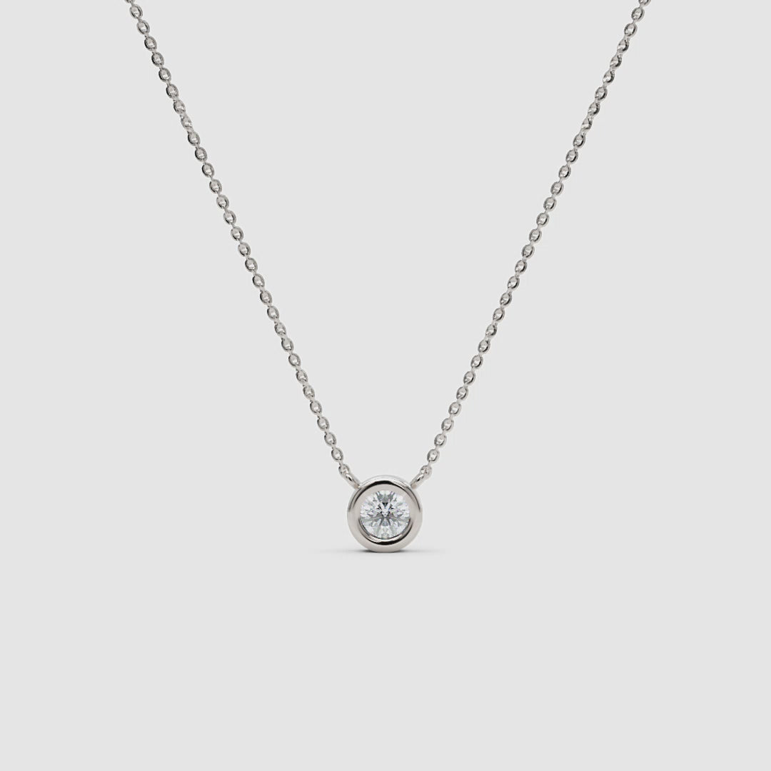 360-degree view of a white gold diamond necklace with a bezel setting, rotating to show the full chain and pendant from all angles.
