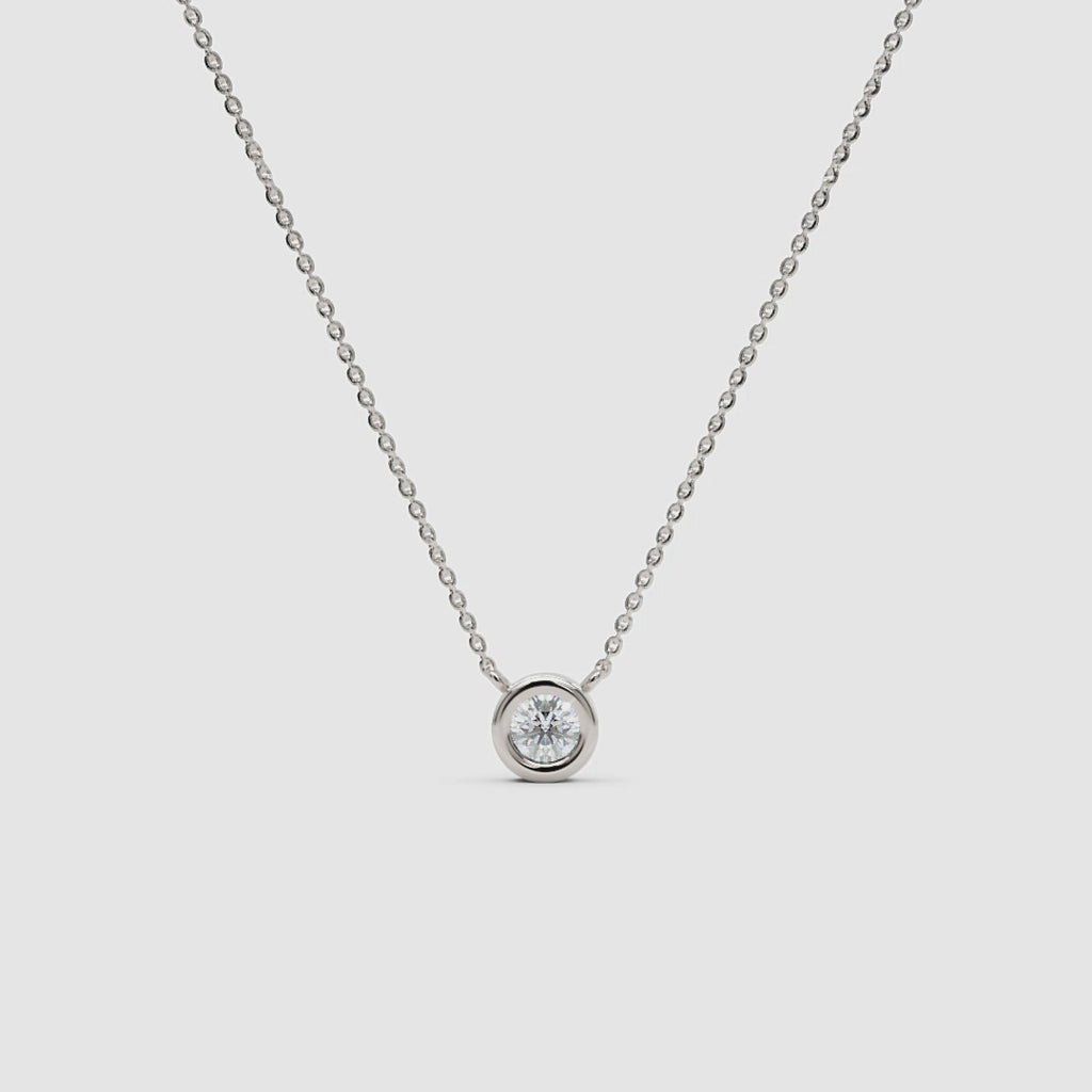 360-degree view of a white gold diamond necklace with a bezel setting, rotating to show the full chain and pendant from all angles.
