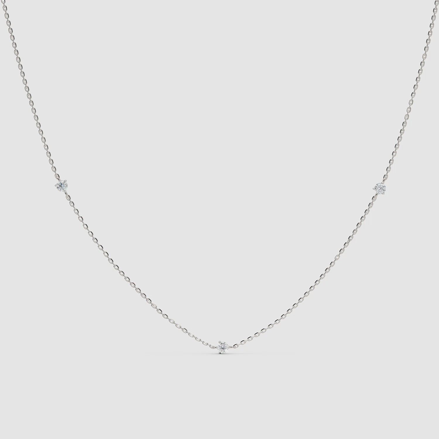 360-degree video of a 14k white gold necklace featuring spaced round diamonds on a delicate chain, rotating to show full detail and sparkle
