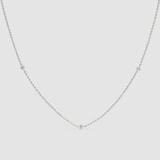 360-degree video of a 14k white gold necklace featuring spaced round diamonds on a delicate chain, rotating to show full detail and sparkle
