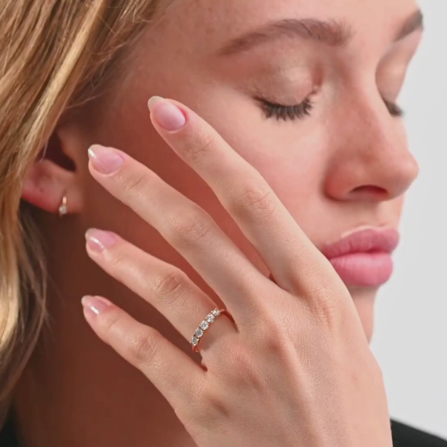 Video of a model gracefully wearing the five-stone diamond ring, capturing the way light reflects off the diamonds from different angles
