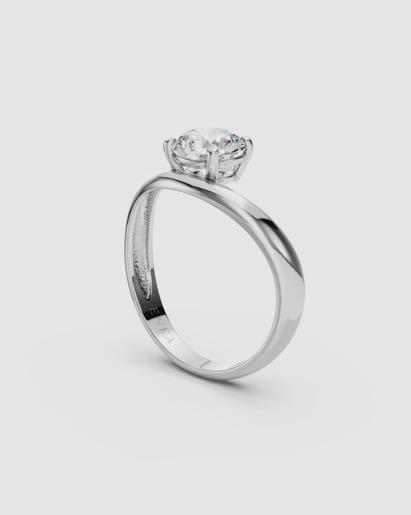spin video giving a 360 view of a solid white gold kyma solitaire band ring with wave design and a round diamond at its center