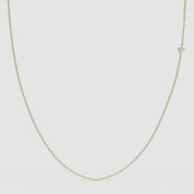 360° view of a minimalist 14k gold chain necklace featuring a small round diamond set off-center, designed to be worn with either side facing forward.
