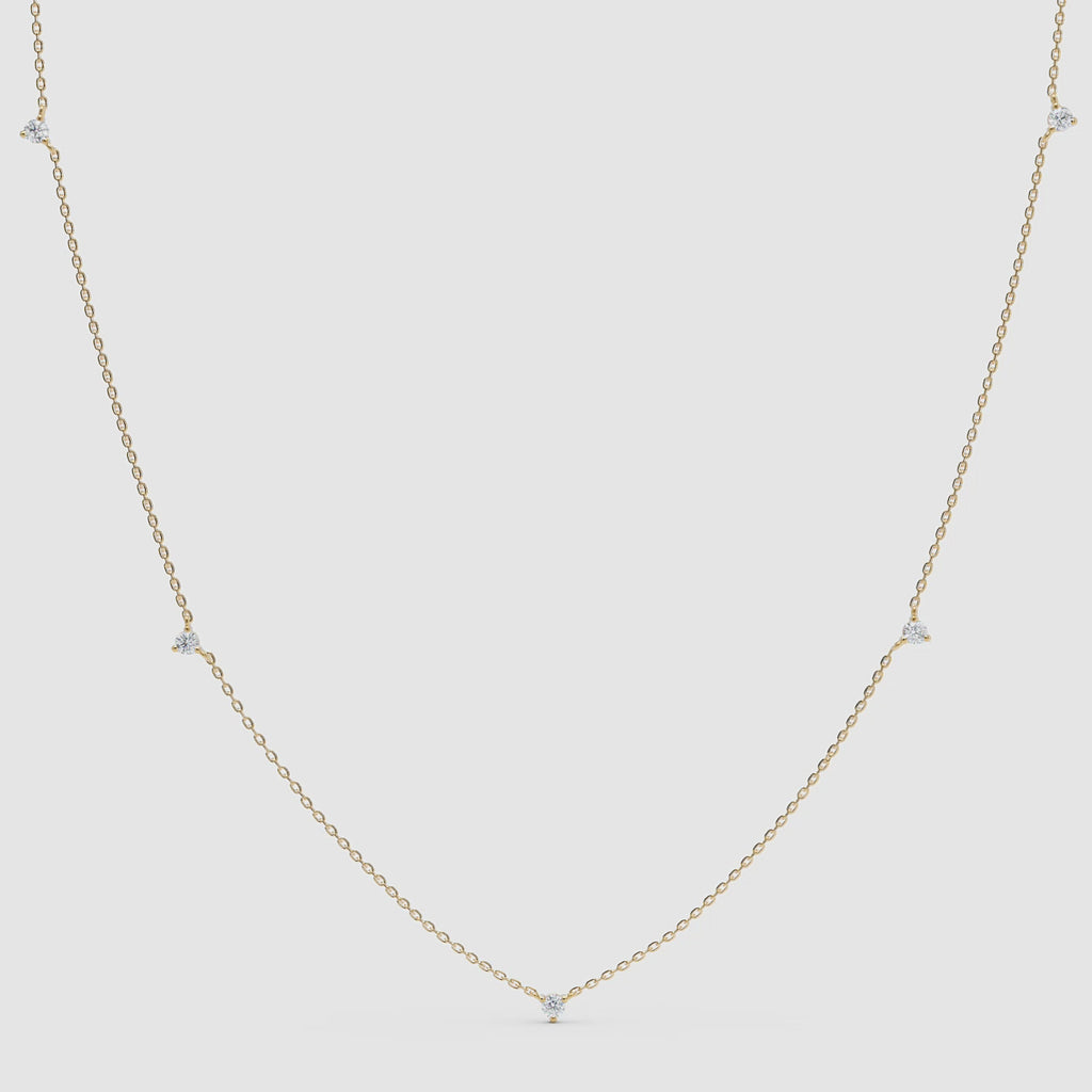 360-degree video of a yellow gold diamond station necklace featuring five small bezel-set diamonds evenly spaced on a fine chain.
